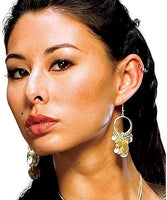 A close-up portrait of a woman wearing a large gold-toned hoop earring with dangling decorative charms, shown against a plain white background.
