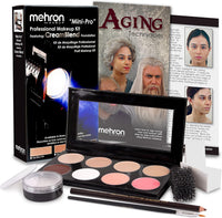 Mehron Makeup 'Mini-Pro' Professional Makeup Kit displayed with its retail box, a cream steamblend foundation palette, cream makeup, brushes, sponges, and an aging techniques guide.