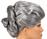 A close-up side profile of a mannequin or model head wearing a vintage-style gray wig with a voluminous updo and bun, shown against a plain white background.