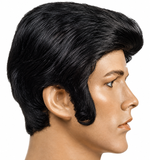 A black 1970s-style pompadour wig with side-swept bangs, shown on a mannequin head in profile against a plain white background.