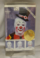 Mehron whiteface clown makeup kit in its original clear plastic packaging, featuring a model photo of a clown with white face makeup, red nose and cheeks, and a black top hat.