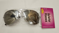 A pair of aviator-style sunglasses in clear plastic packaging with a bright pink retail card labeled 'Aviator Glasses.' The lenses are dark gray, and the frame appears silver-toned.
