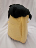 A plush character head mask with a pale yellow felt body and a black fuzzy top section, photographed against a white fabric backdrop.
