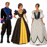 Three people wearing elaborate historical costume dresses and a matching crown stand against a plain white studio background. The set includes a man in a black velvet costume with bright blue ruffles and gold trim, a woman in a black gown with a large gold front panel and multicolored diamond pattern, and a woman in a white gown with green trim and gold embroidery.
