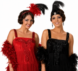 Two women modeling 1920s flapper costumes against a white background. The woman on the left wears a red sequined fringed dress with a red and black feather headband and matching feather boa.