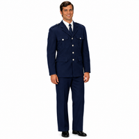 A man modeling a navy blue military-style uniform jacket and matching trousers, worn over a white dress shirt and dark tie, against a plain white background.