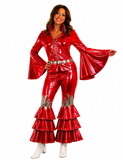 A woman modeling a shiny red two-piece costume set with flared bell sleeves, a silver embellished belt, and tiered ruffle flare pants, paired with white heeled boots against a plain white background.