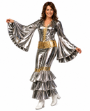 A woman modeling a metallic silver and gold 1960s-style rock star costume with flared bell sleeves, a ruffled hem, and white heeled boots against a plain white background.