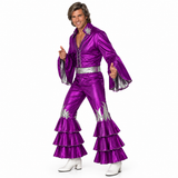 A man modeling a shiny purple Elvis-style costume jumpsuit with silver trim, silver belt, silver floral embellishments, and white heeled boots against a plain white background.