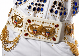 A close-up of a white military-style uniform belt with ornate gold eagle emblems, red oval stones, star details, and draped gold chains, worn with a white embellished jacket.