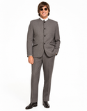 A man wearing a gray two-piece suit with a mandarin collar blazer, white dress shirt, and black dress shoes, standing against a plain white background.