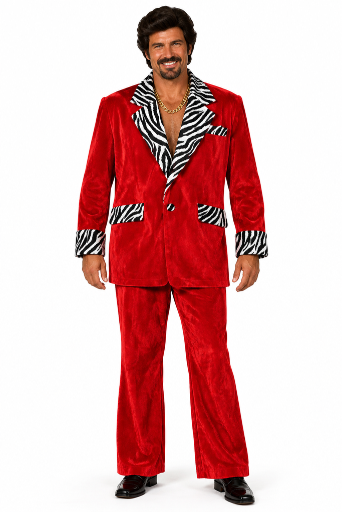 A man modeling a red velvet two-piece suit with black and white zebra print lapels, pocket flaps, and cuffs, paired with black dress shoes against a white background.