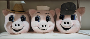 Three Little Pigs Costumes with different hats on a wooden surface.